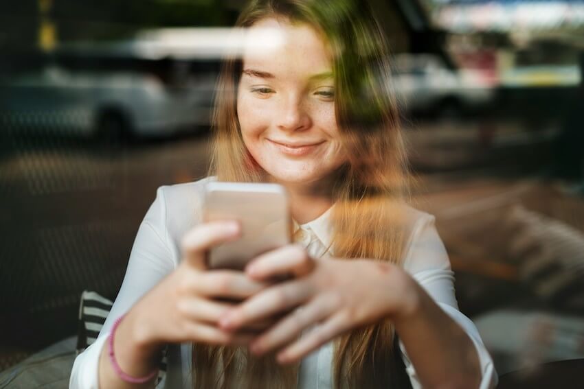smiling woman texting a friend