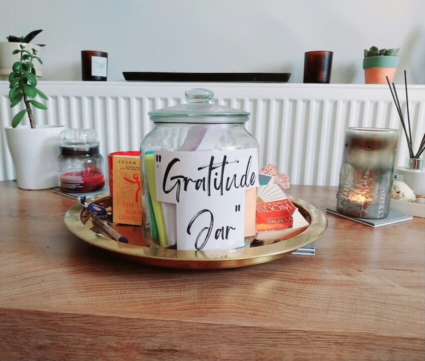 homemade gratitude jar present in the center of a living room table