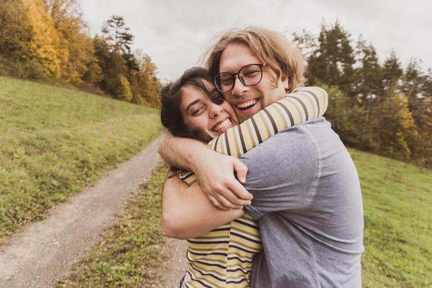 two friends embraced in a happy hug