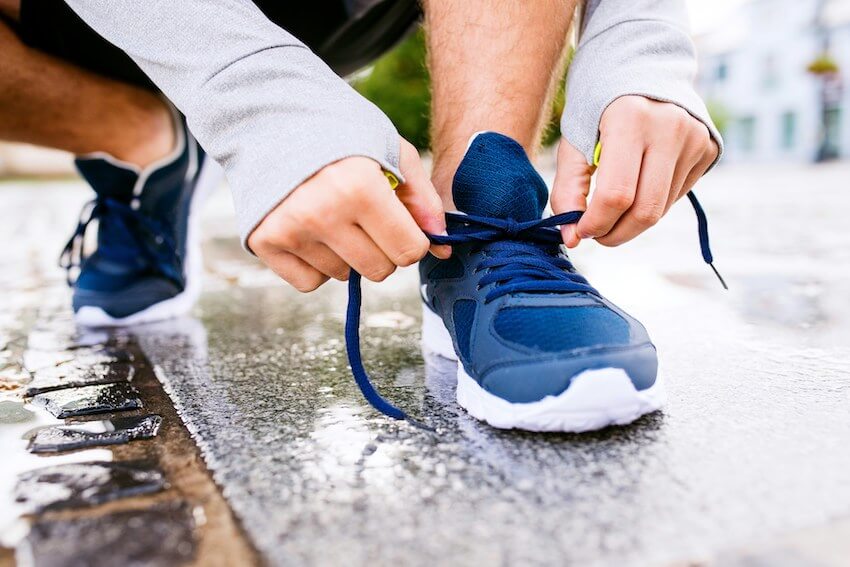 man tying his shoelaces