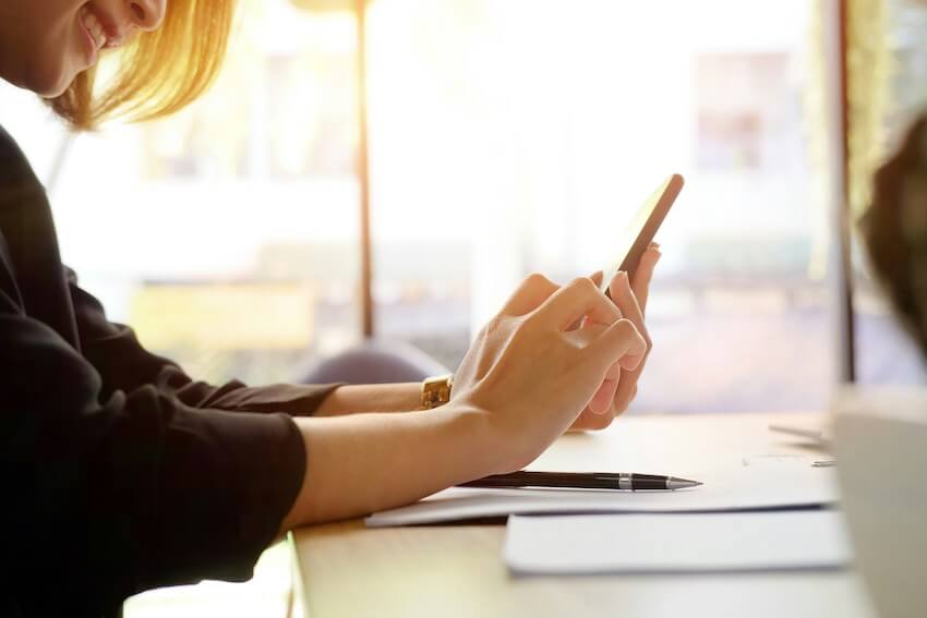 smiling woman texting a friend