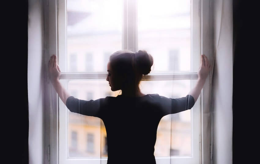 woman opening the blinds