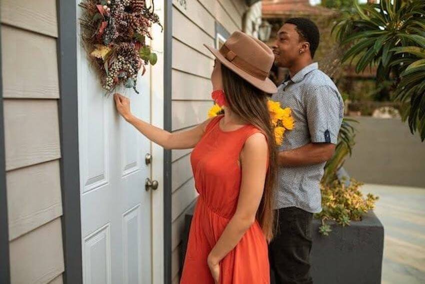 couple bringing flowers to their neighbor