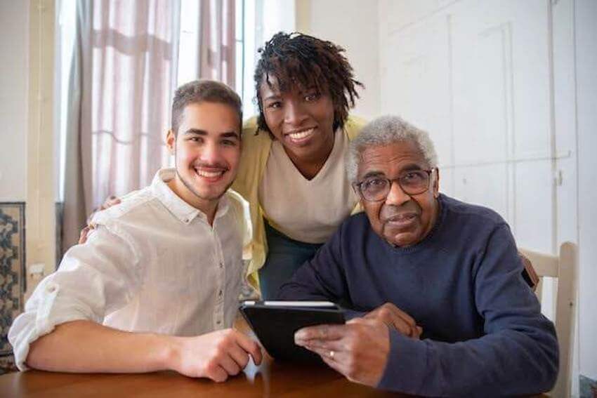 man and woman visiting an elderly man