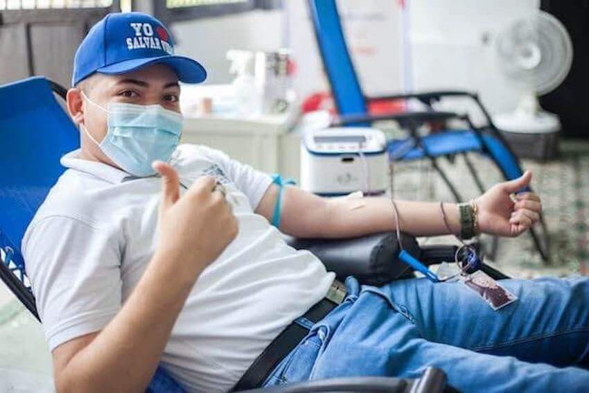 man giving a thumbs up while donating blood