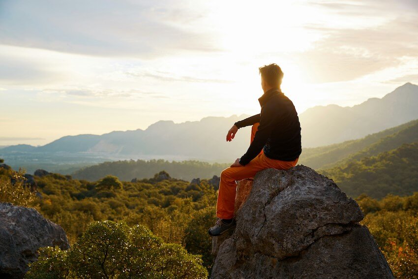 male hiker looking at the mountains in the distance