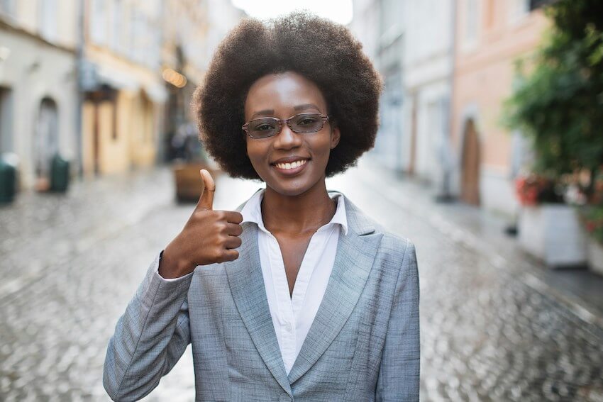 smiling woman with her thumbs up