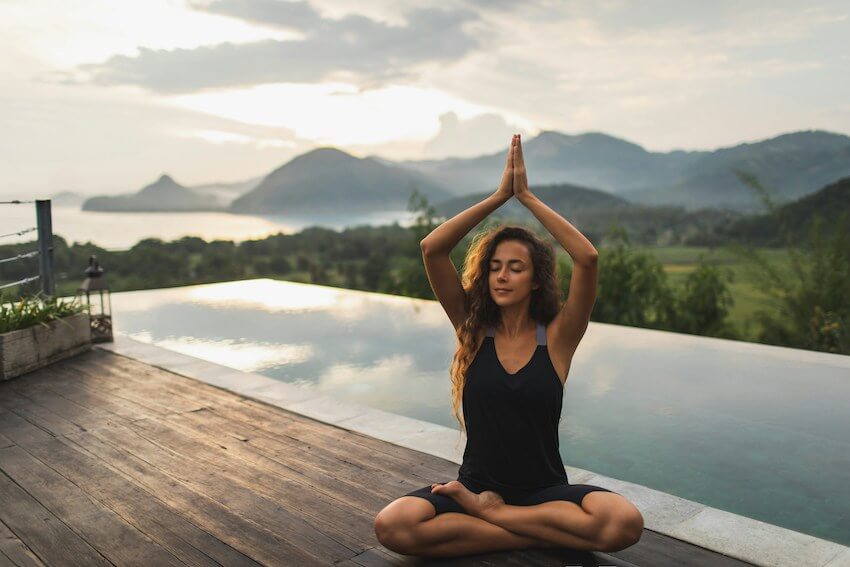 woman sitting in a yoga pose outside