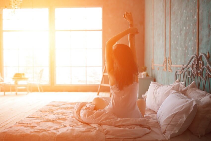 woman stretching as she wakes up in the morning