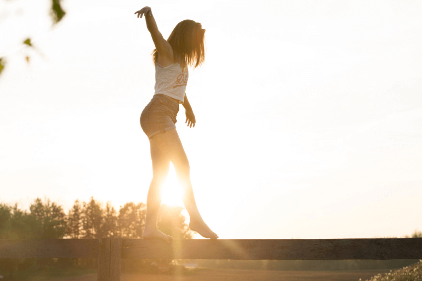 woman balancing on a beam