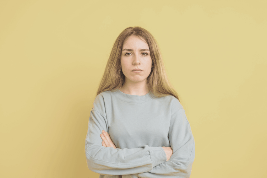 woman with her arms crossed, feeling resentful