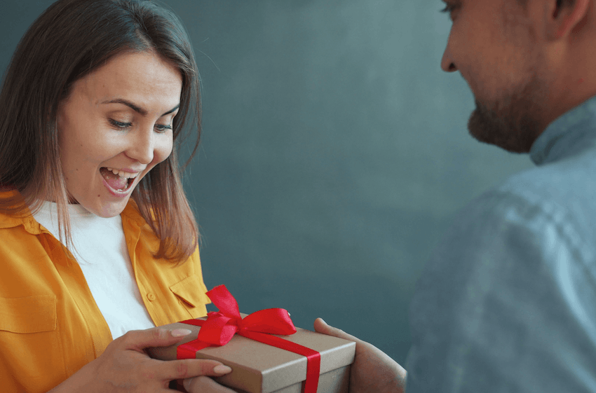 woman smiling as she receives a thank you gift