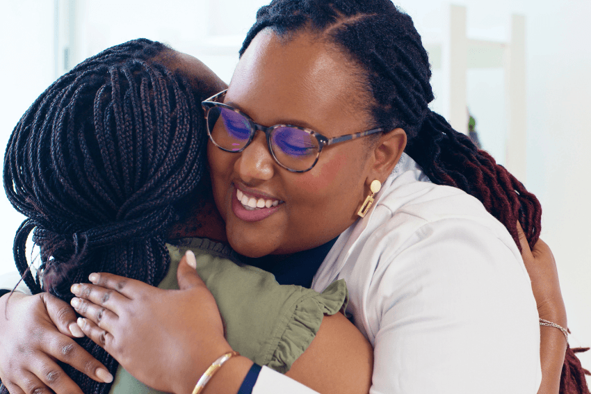 A doctor hugging her patient warmly and genuinely, the kind of real connection that people who are caring too much create without even trying.